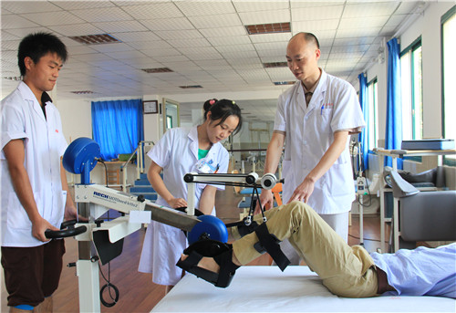 科主任楊釗(右一)指導(dǎo)治療師給患者進(jìn)行下肢智能訓(xùn)練儀治療.jpg